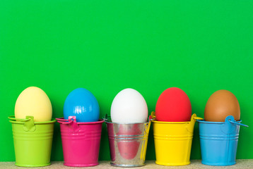 Easter eggs in colored buckets, selective focus image, Card Happy Easter 