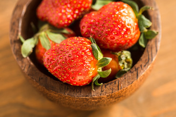 strawberries in wooden bowl