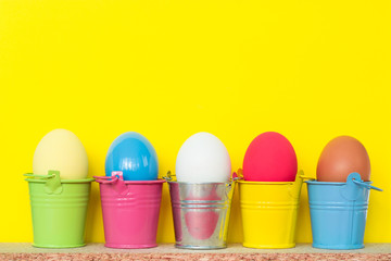 Easter eggs in colored buckets, selective focus image, Card Happy Easter 
