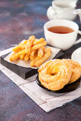 Eclairs and tea on a table. Selective focus. Copy space. Top view