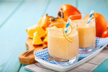 Orange persimmon smoothie with granola  and fruits. Selective focus. Copy space