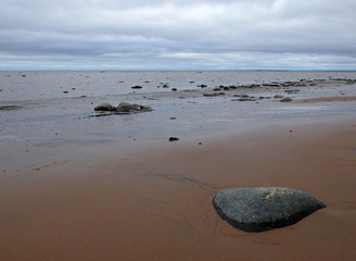 The lonely stone on the shore of White Sea at low tide in North Russia