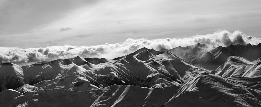 Fototapeta Black and white panorama of evening snow mountains at winter