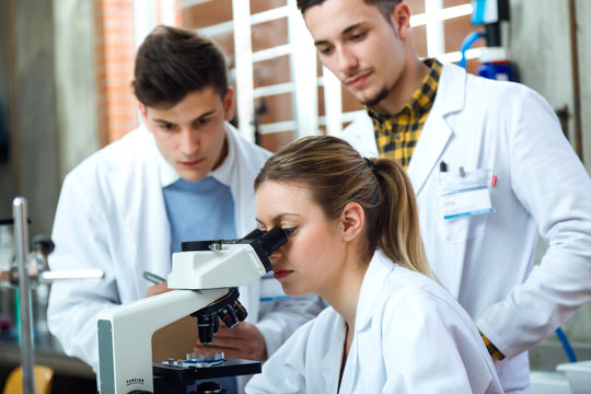 Young scientists carrying out an experiment in a laboratory.