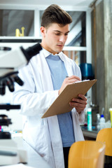 Handsome young man working in laboratory.
