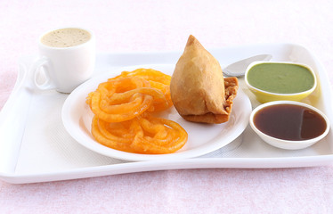 Jalebi and samosa, Indian vegetarian food with their origins in north India, and coffee and chutneys.