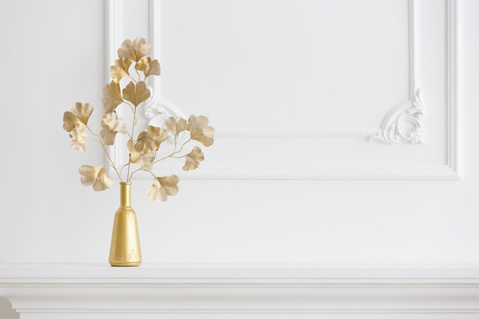 White Interior. A White Fireplace In A Light Interior And A Gold Vase. Classical Interior