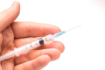 Hand holding a syringe