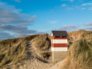 Small red and white striped hut
