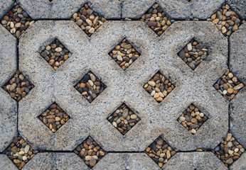 Concrete block with small stones on walk path, top view