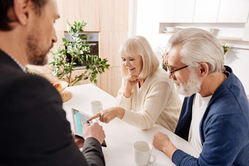 Ambitious real estate agent working with retired couple of clients