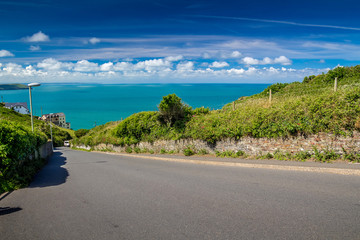 The road between Woolacombe and Mortehoe. In the background, you can see the sea bay and the house. Good warm weather. Summer. North Devon. England