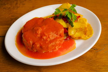 Tuna fish dish with tomato sauce and potatoes
