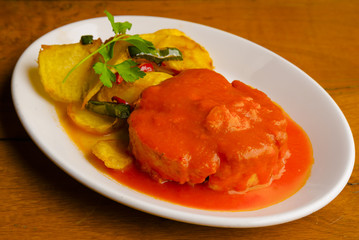 Tuna fish dish with tomato sauce and potatoes