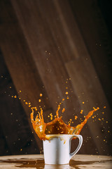 Coffee exploding out of white mug
