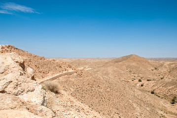 Destroyed long stone walls in the desert