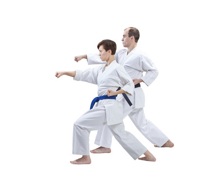 With black belt and blue belt the athletes are training punch arm