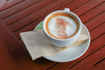 coffee cappuccino on the wood floor background