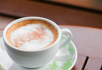 close up coffee cappuccino on the wooden floor background