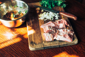 Raw fresh Lamb Meat ribs and seasonings on wooden background.