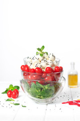 Green salad, cherry tomatoes, mini mozzarella. Organic food on a white background