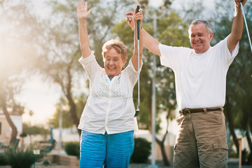 senior couple celebrating playing miniature golf