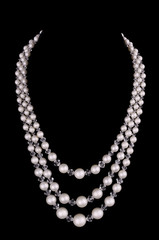  White pearls luxury necklace on black background