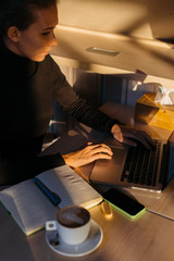 Woman's hands on keyboard and laptop in sunset light