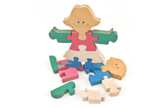 Colorful wooden girl standing on boy puzzle pieces isolated on white