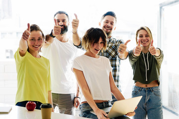 Team of young marketing managers are celebrating the launch of the new product promotion project....