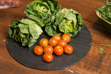 Ingredients for lettuce salad cherry tomatoes and arugula