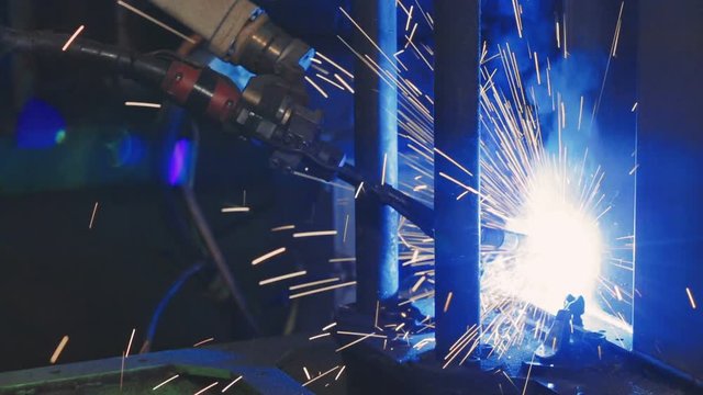 Automation mechanical procedure. Factory welding. Industrial Robot arm. Close-up