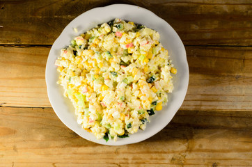 Salad with crab sticks, corn, cucumber, and eggs