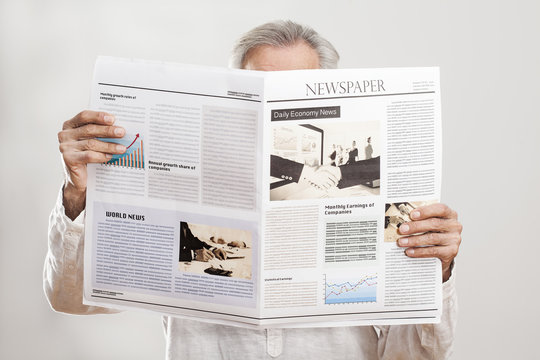 Portrait elderly man reading newspaper