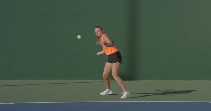 Tennis player plays forehand shot.