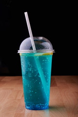 Blue drink in plastic glass.