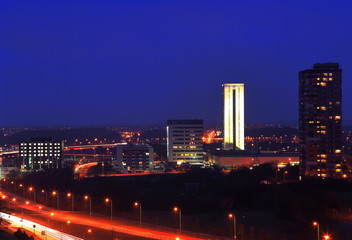 Fototapeta na wymiar White skyscraper at the night background