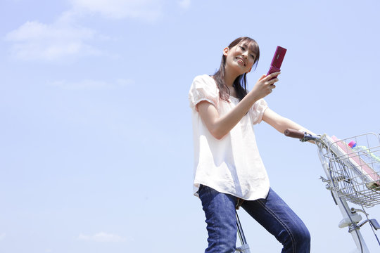 Woman texting while on a bike ride