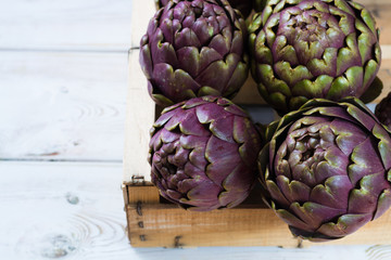 Obraz premium Fresh big Romanesco artichokes green-purple flower heads ready to cook
