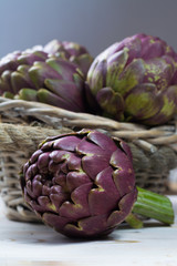 Obraz premium Fresh big Romanesco artichokes green-purple flower heads ready to cook
