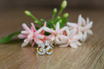 Ganesh spell ring for good luck and bunch of flowers on wooden table