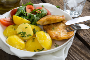 Schnitzel with potatoes and greens