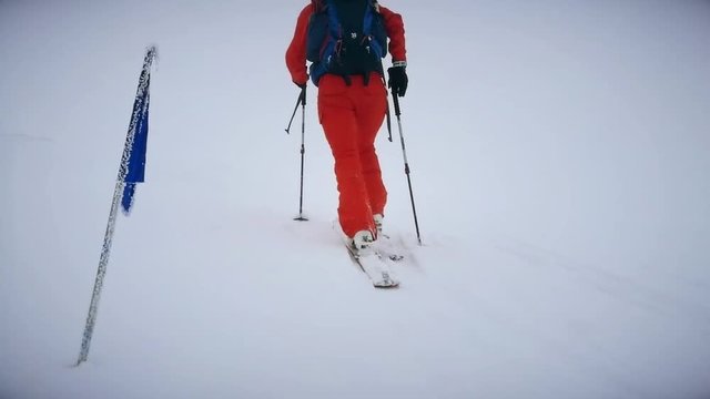 Ski mountaineer competes in a ski touring competition on a foggy day