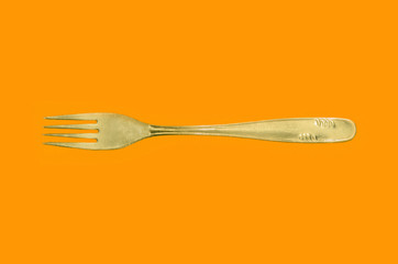 fork on yellow background