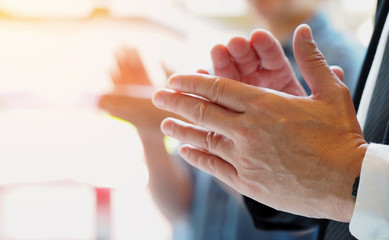 Group of business people clapping their hands at the meeting