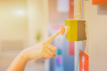 Emergency button on machine in factory by man hand,selective focus vintage color