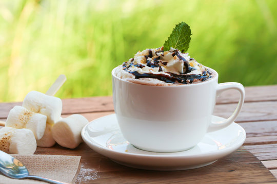 Whipped cream on hot chocolate cup 