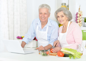 Beautiful elderly couple preparing breakfast