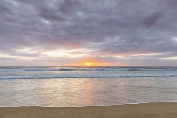 Naklejka na ściany i meble Cloudy and colourful beach sunrse on the Gold Coast
