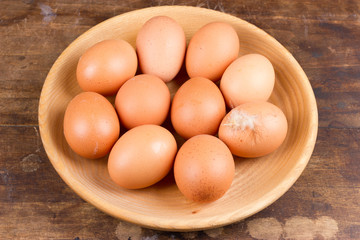 Eggs on wooden plate